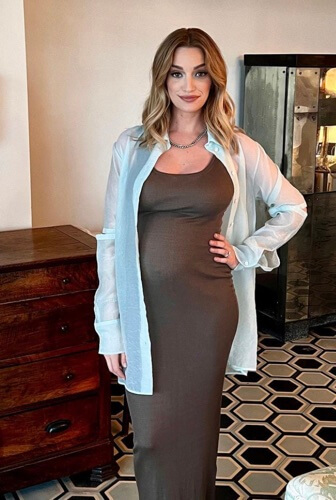 Brianne Howey posing with her baby bump.